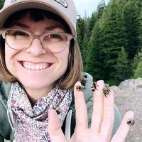 Sylvan Zimmerman with several bumble bees on fingers